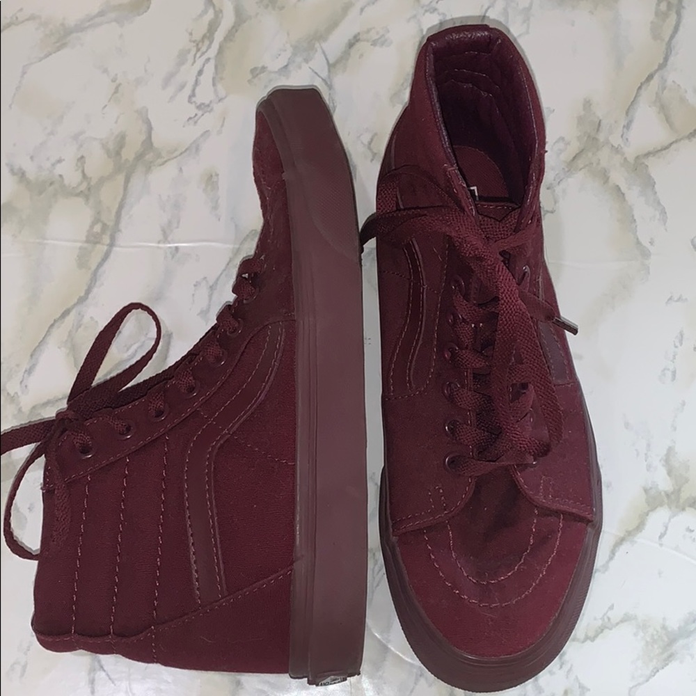 Maroon high top Vans shoes